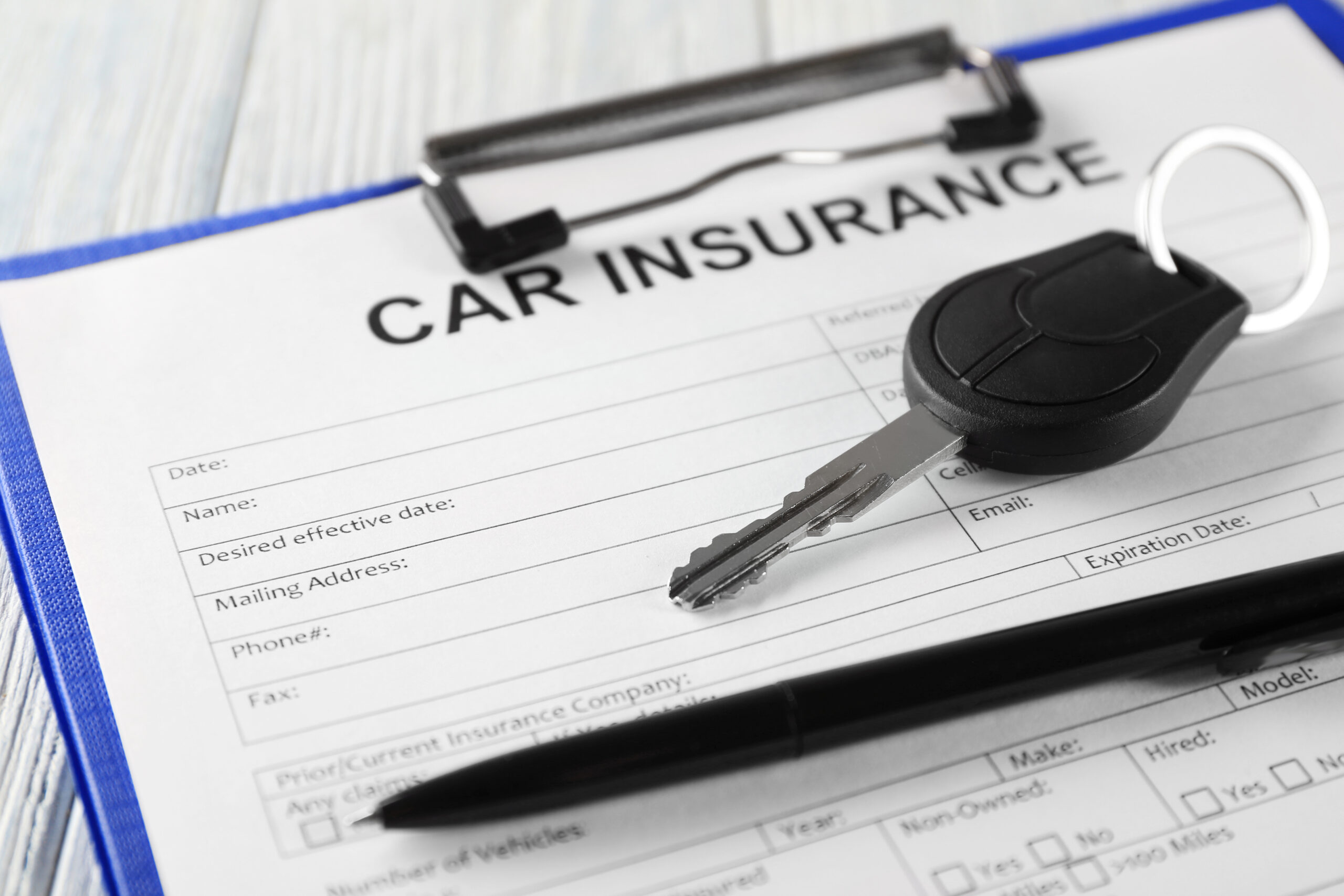 Car,Insurance,Form,And,Key,On,Table
